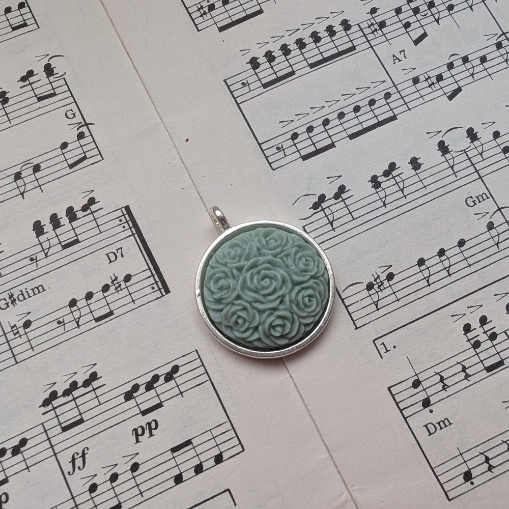 Silver Pendant with Green Rose Design